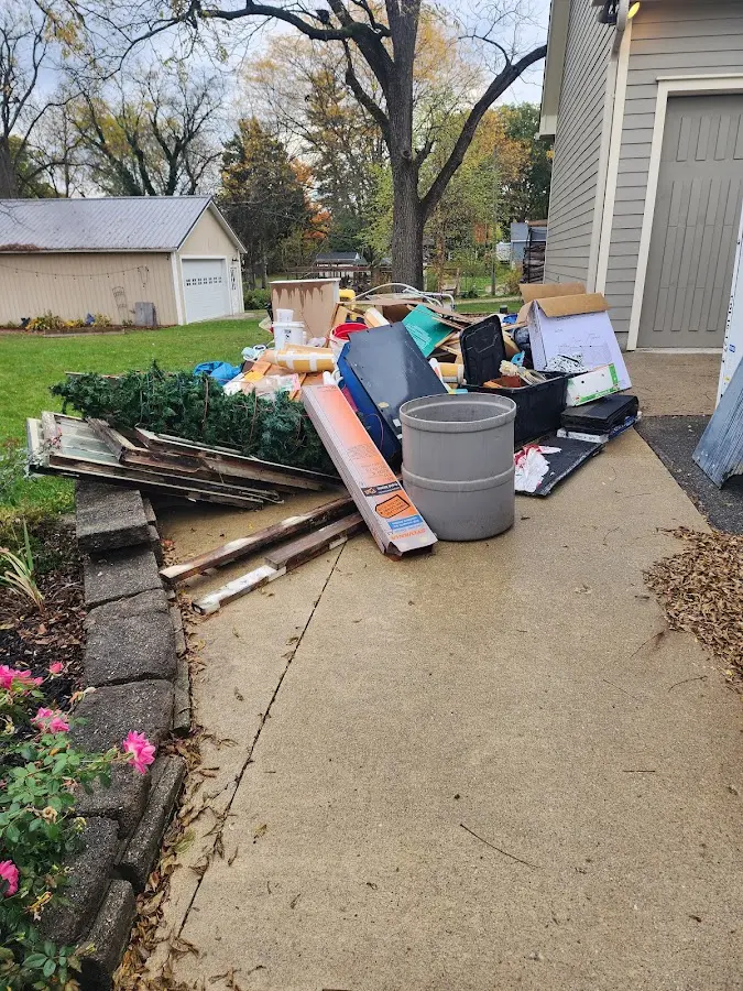Dumpster being loaded with debris for Commercial Dumpster Rental in Rib Mountain